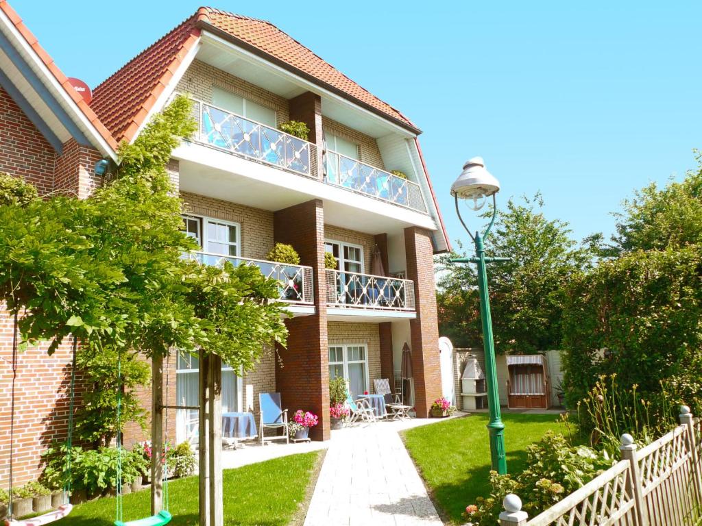 a house with a balcony and a street light at Apartment Dehne-2 by Interhome in Norddeich