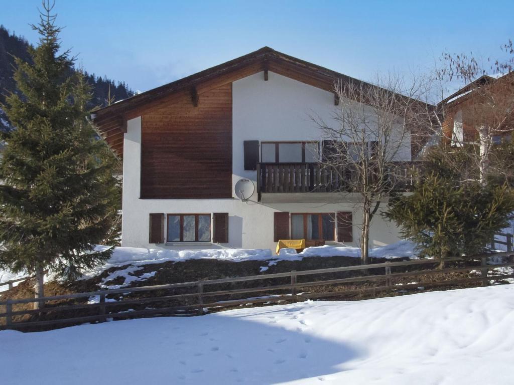 a house in the winter with snow in front of it at Chalet Haus Murena by Interhome in Schmitten