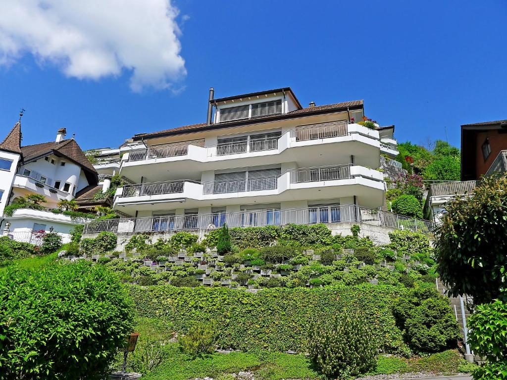 a large white building on top of a hill at Apartment Hegglistrasse 9-1 by Interhome in Buochs