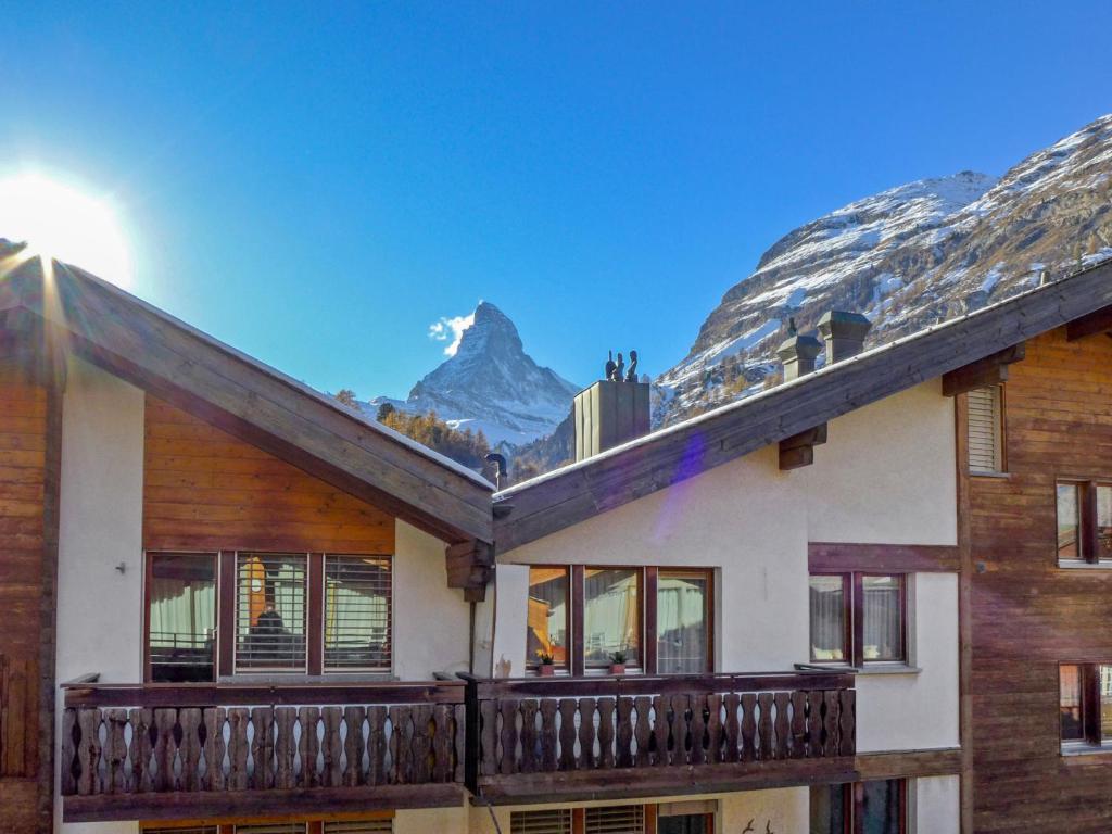 a house with a balcony with a mountain in the background at Apartment Rütschi-7 by Interhome in Zermatt