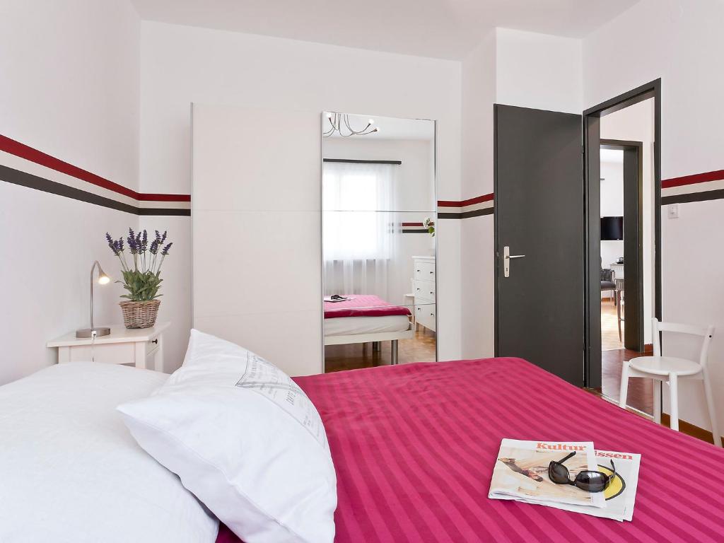 a bedroom with a bed with a book on it at Apartment Junior Suite-8 by Interhome in Ascona