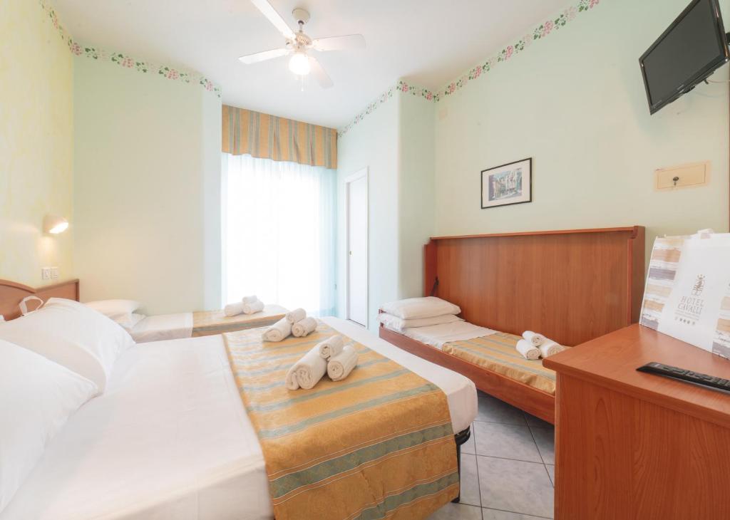 Postel nebo postele na pokoji v ubytování Hotel Cavalli