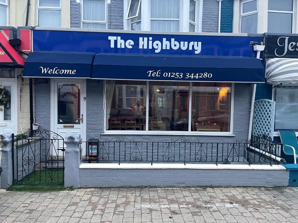 a restaurant with a blue awning on a building at Highbury Hotel in Blackpool