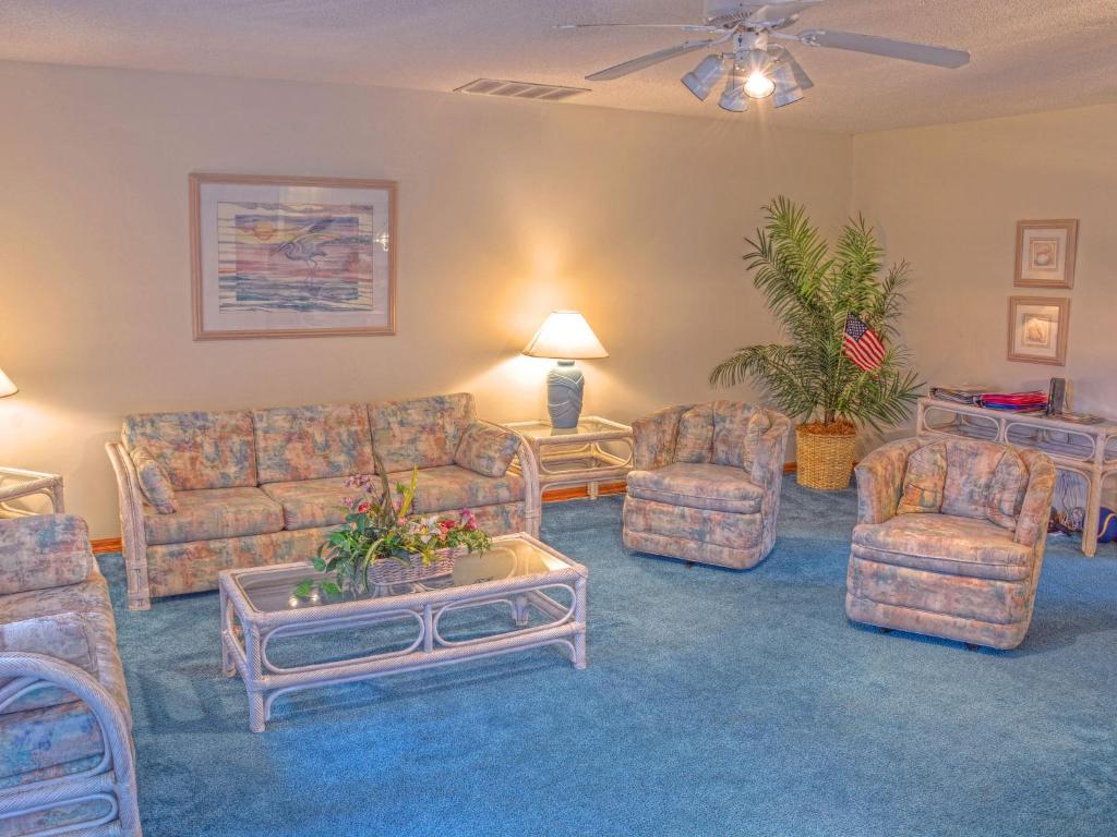 a living room with couches and chairs and a table at Holiday Home Sunrise by Interhome in Palm Coast