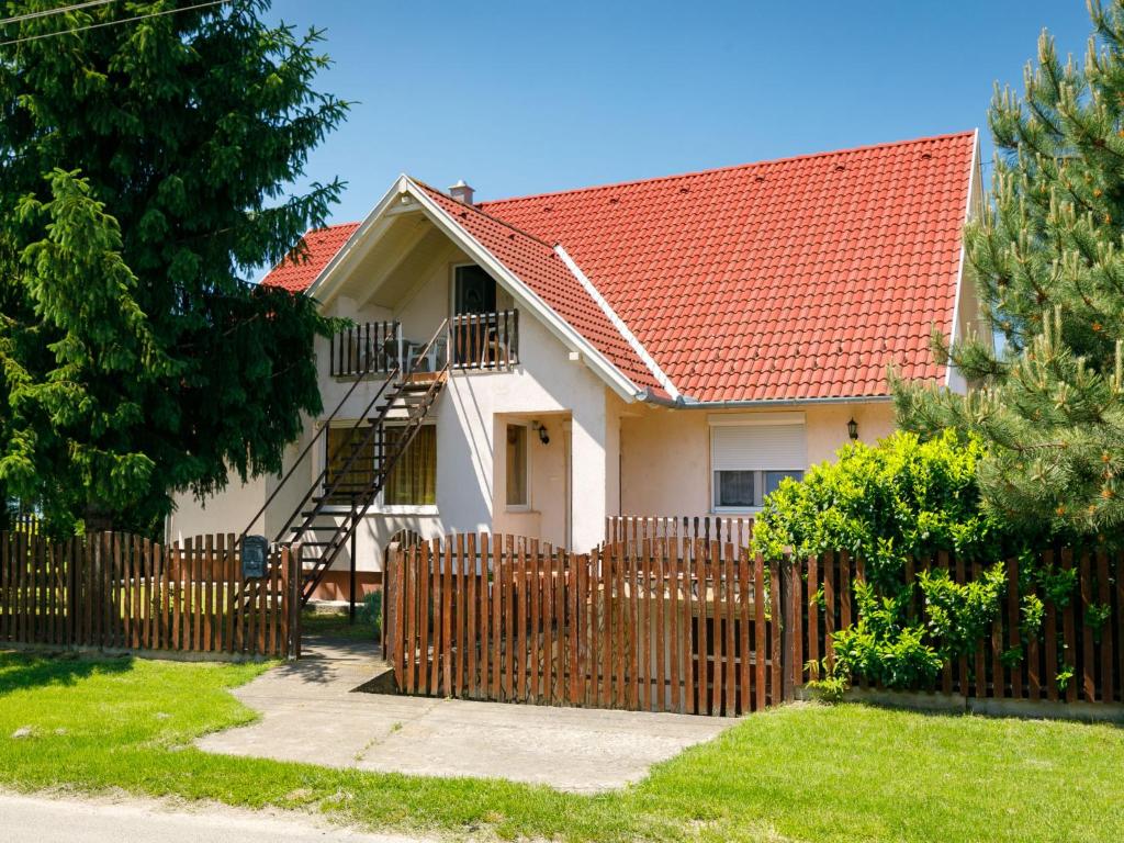 a house with a wooden fence in front of it at Apartment Scarlett 1 by Interhome in Balatonszemes