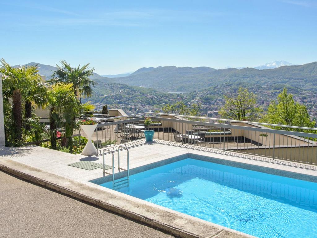 a swimming pool on the roof of a house at Apartment Residenza Monte Bré - Apt-204 Haus1 by Interhome in Lugano