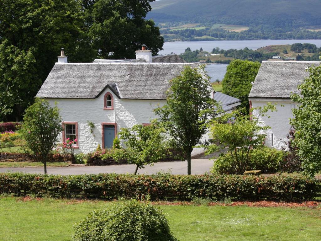 a white house with a view of a lake at Holiday Home Lorn Mill-2 by Interhome in Balloch