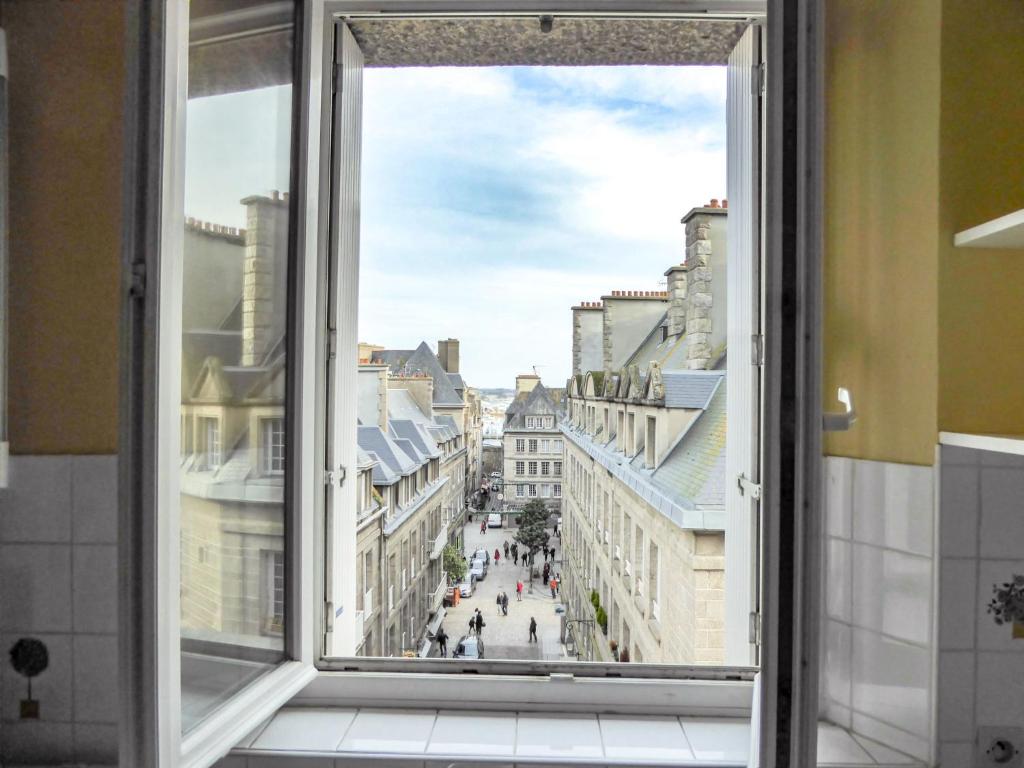 a window with a view of a city at Apartment Beauchesne by Interhome in Saint Malo