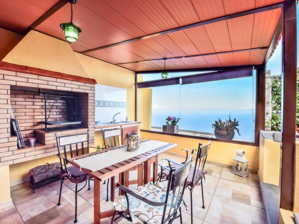 a dining room with a table and chairs and a fireplace at Holiday Home Titi in Fuencaliente de la Palma