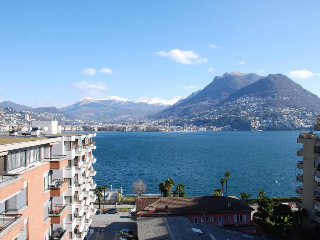 a view of a large body of water with mountains at Apartment App- Paradiso by Interhome in Paradiso
