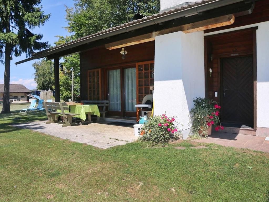 a house with a table and a bench in the yard at Holiday Home Rustika by Interhome in Obermieger