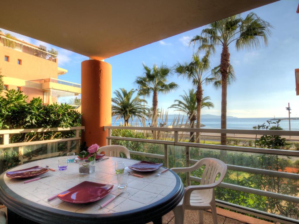 une table et des chaises sur un balcon avec vue sur l'océan dans l'établissement Apartment Villa Medicis-1 by Interhome, à Cavalaire-sur-Mer