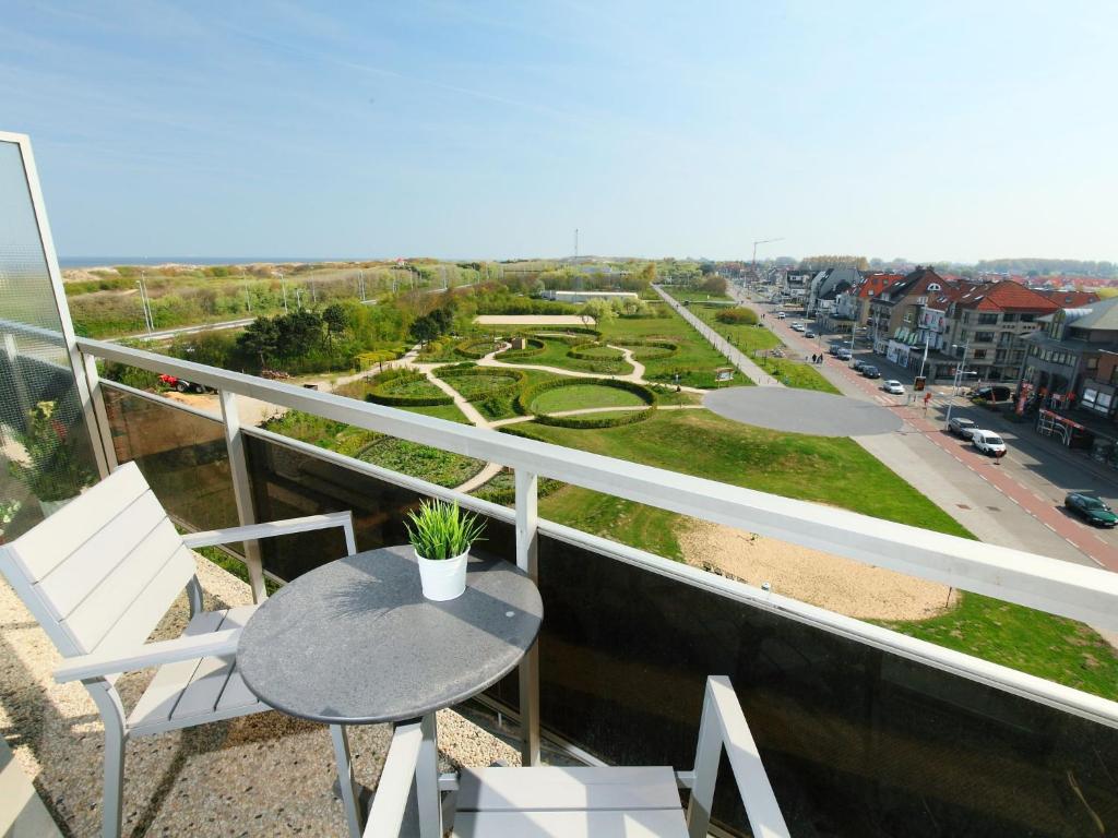 a balcony with a table and a view of a city at Studio Residentie Astrid-5 by Interhome in Bredene