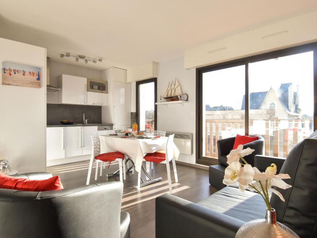 a kitchen and living room with a table and chairs at Apartment Baccara by Interhome in Deauville