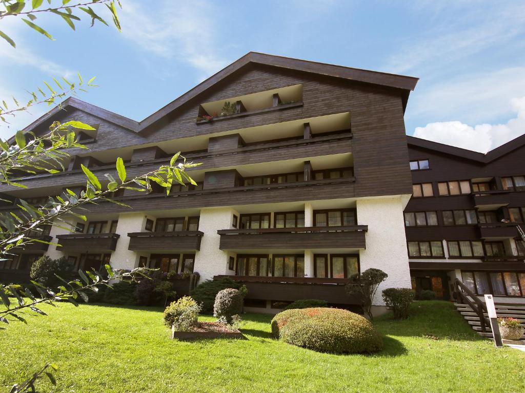 a large building with a lawn in front of it at Apartment Schlossalmblick by Interhome in Bad Hofgastein