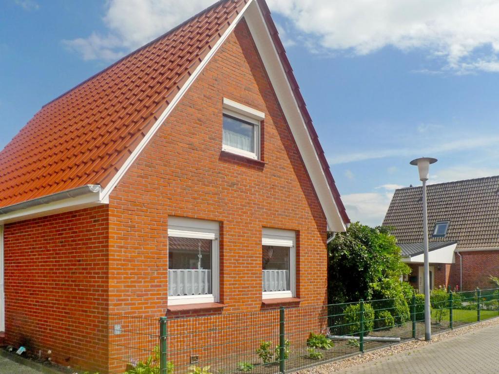 ein rotes Backsteinhaus mit rotem Dach in der Unterkunft Holiday Home Hexenhuus by Interhome in Hage