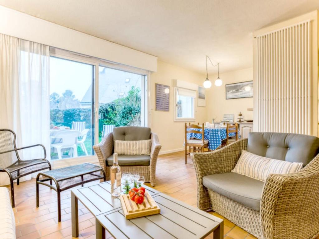 a living room with chairs and a table at Apartment Les Galiotes-1 by Interhome in Carnac-Plage