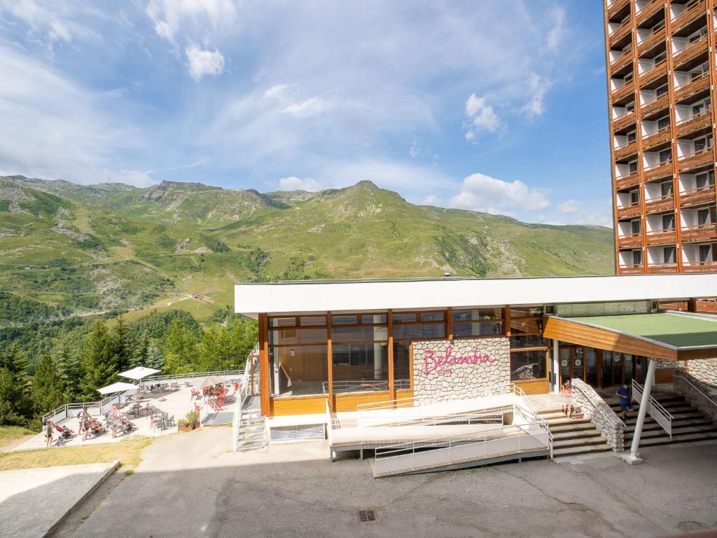 a building with a sign in front of a mountain at Apartment Les Lauzes-3 by Interhome in Les Menuires