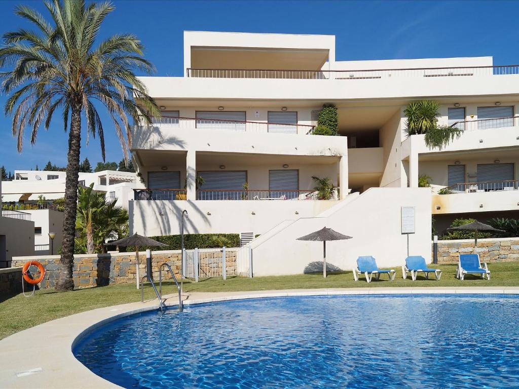 a hotel with a swimming pool in front of a building at Apartment Lomas de Los Monteros by Interhome in Marbella