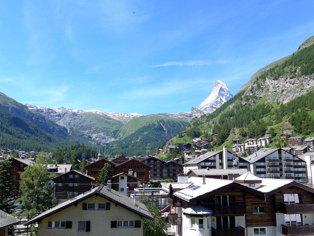 a town in the mountains with a snow covered mountain at Apartment Granit-5 by Interhome in Zermatt