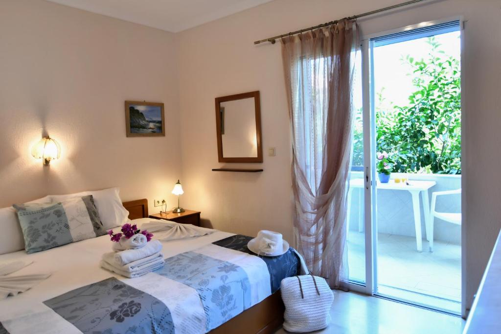 a bedroom with a bed and a sliding glass door at Haus Despina in Sarti