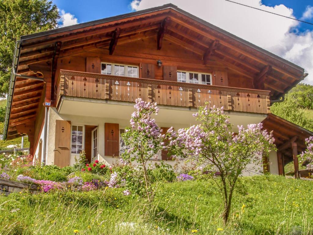 ein Haus mit einer Terrasse und Blumen davor in der Unterkunft Holiday Home Chalet Reinhysi by Interhome in Grindelwald