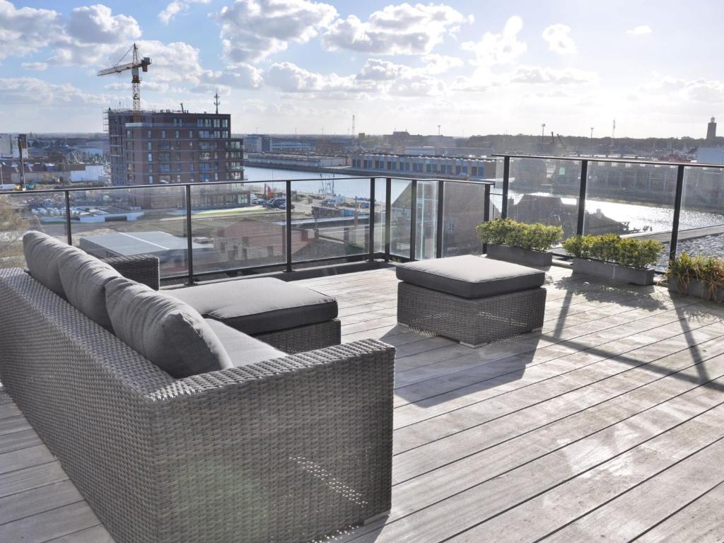 a balcony with couches and a view of a city at Apartment Victoria by Interhome in Ostend
