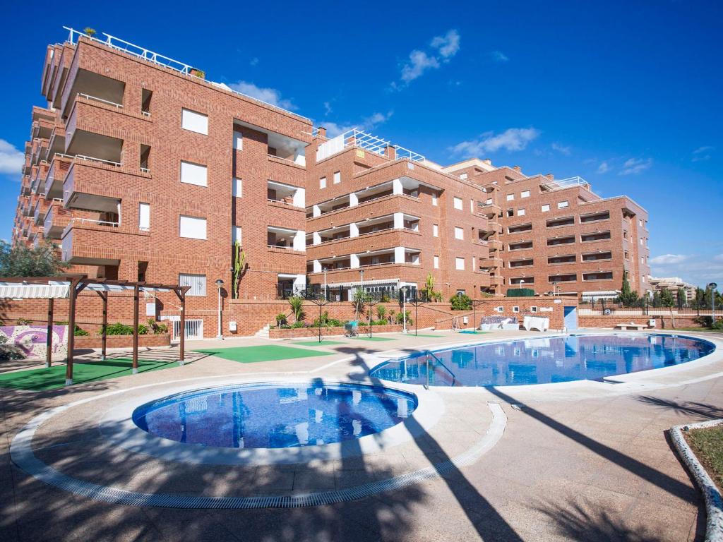 an apartment complex with a pool in front of a building at Apartment Playa Coral I-1 by Interhome in Oropesa del Mar