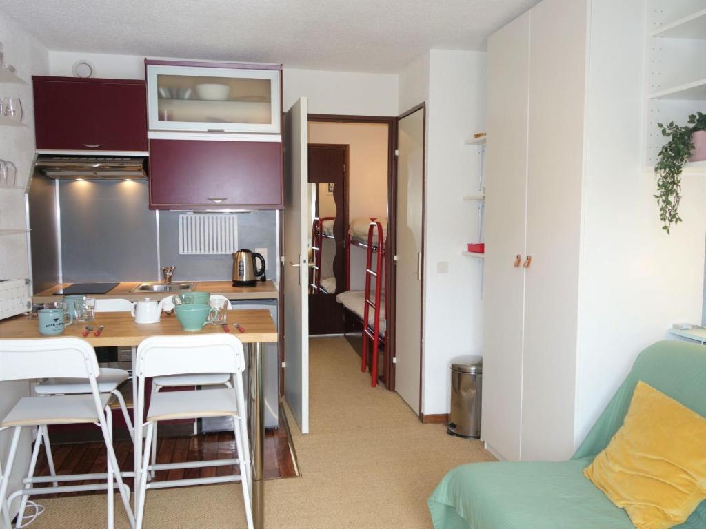 a small kitchen with a table and chairs in a room at Studio Le Sapin-1 by Interhome in Demi-Quartier