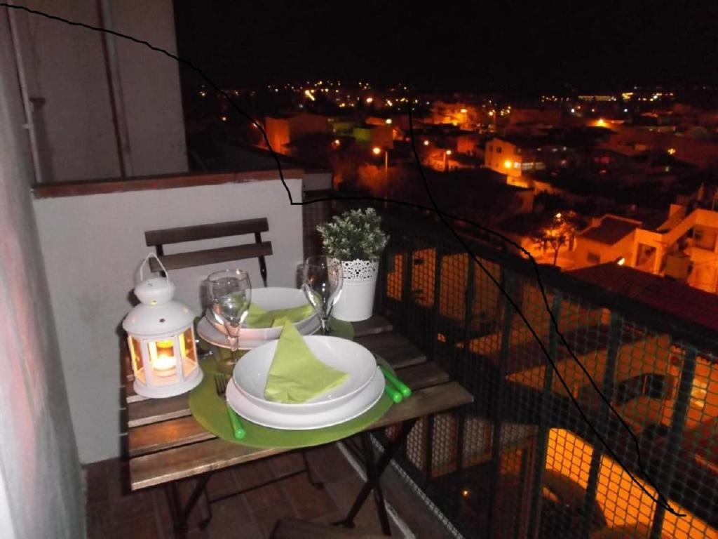 a table with plates and wine glasses on a balcony at Sea & You Algarve Apartment in Lagos