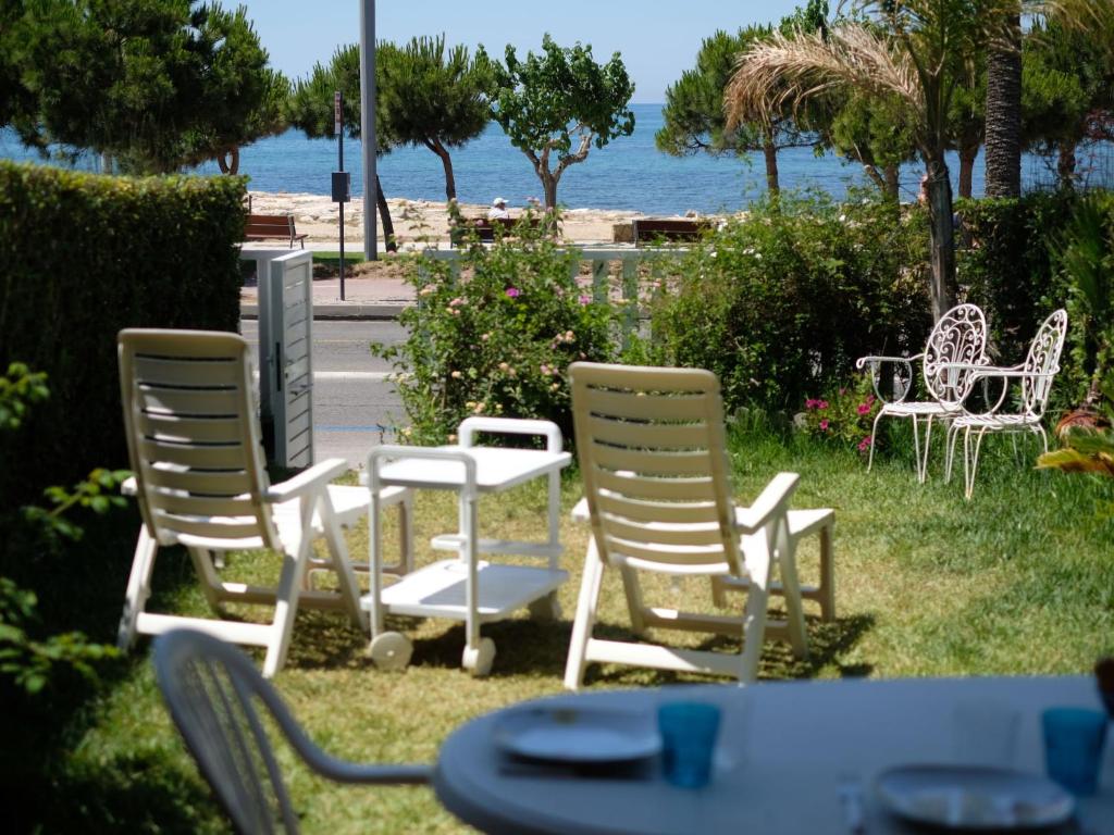 a group of chairs and tables with the ocean in the background at Apartment Costa Blanca II by Interhome in Cambrils