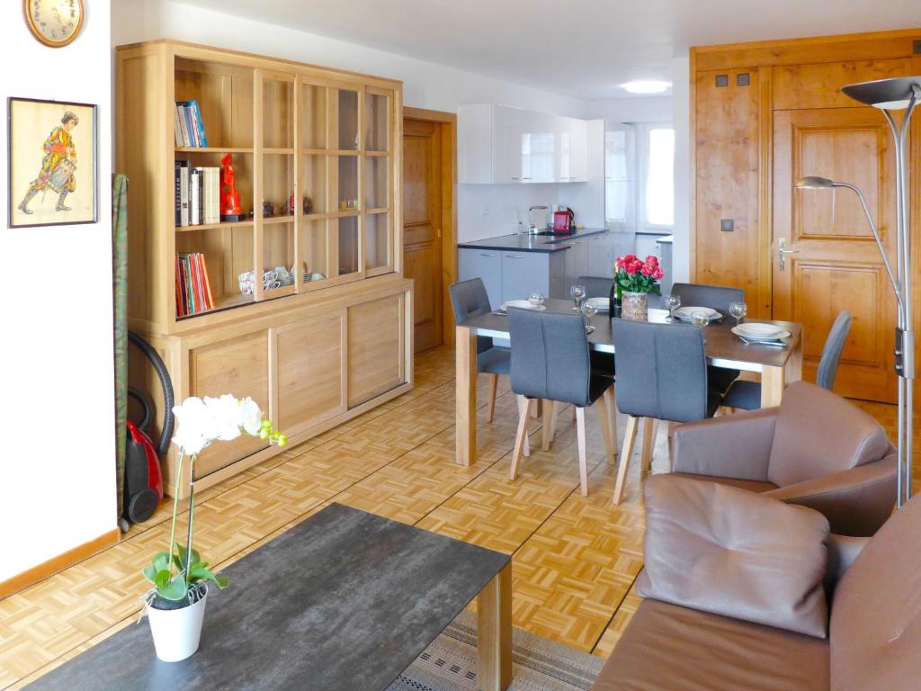 a kitchen and dining room with a table and chairs at Apartment Grand Large A-B-3 by Interhome in Crans-Montana