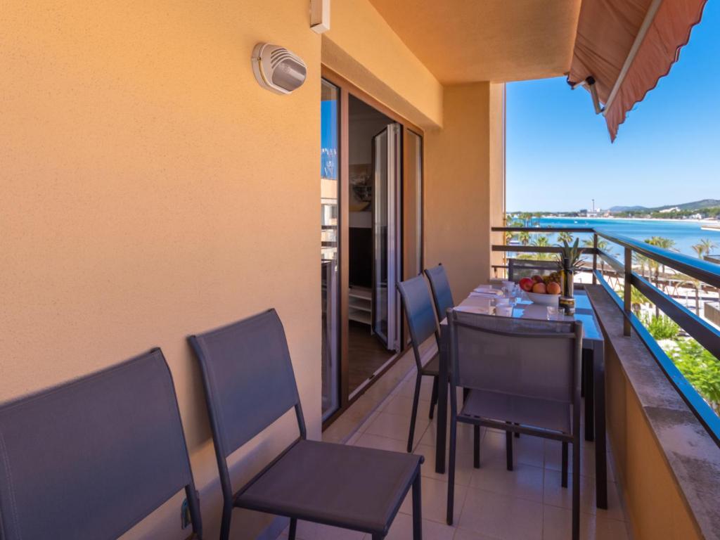 a restaurant with a table and chairs on a balcony at Apartment Mariners 4 by Interhome in Alcudia