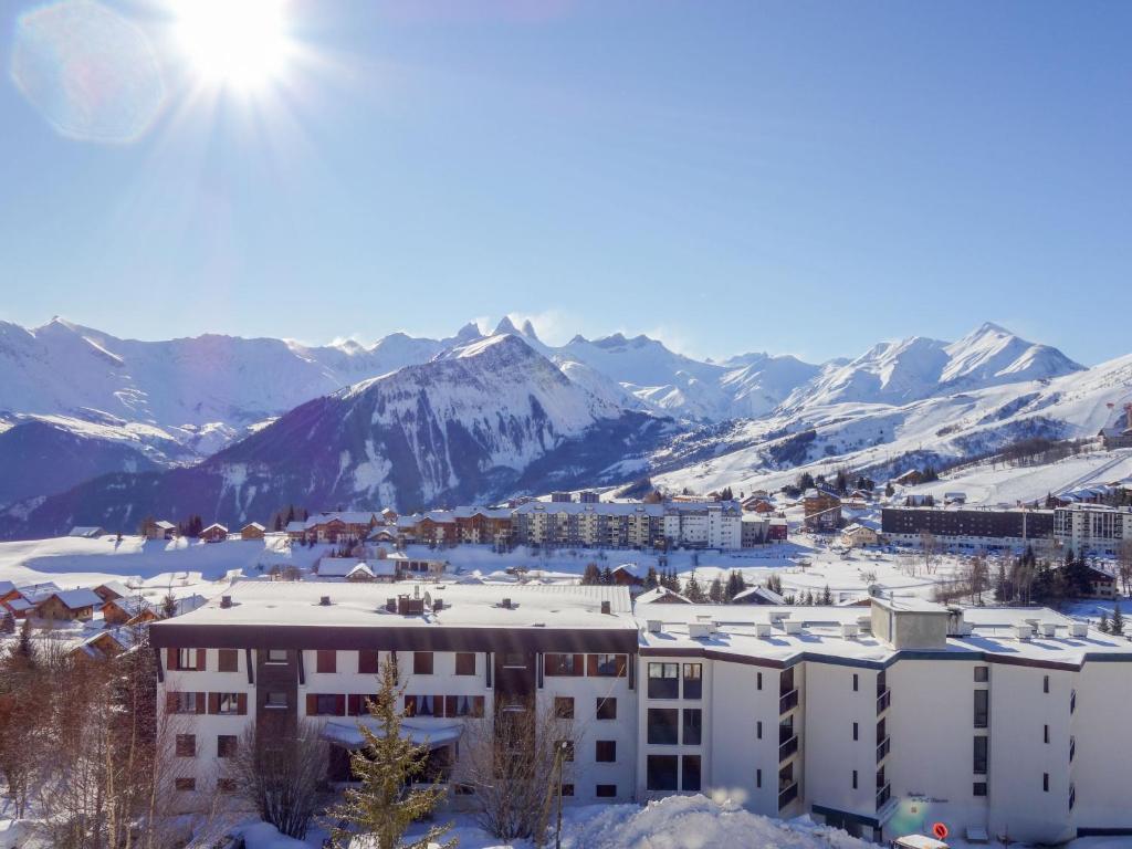 a city in the snow with mountains in the background at Apartment Champ Bozon by Interhome in La Toussuire
