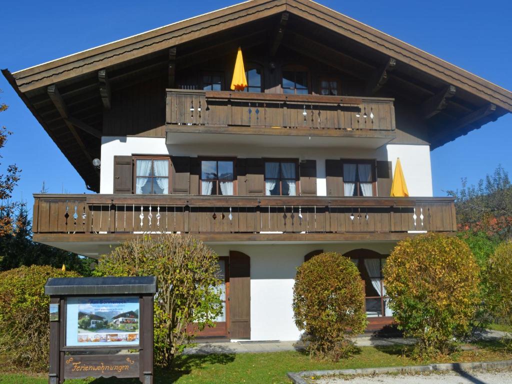 a building with a balcony and a sign in front of it at Apartment Wohnung 4 - Am Sonneneck by Interhome in Ruhpolding