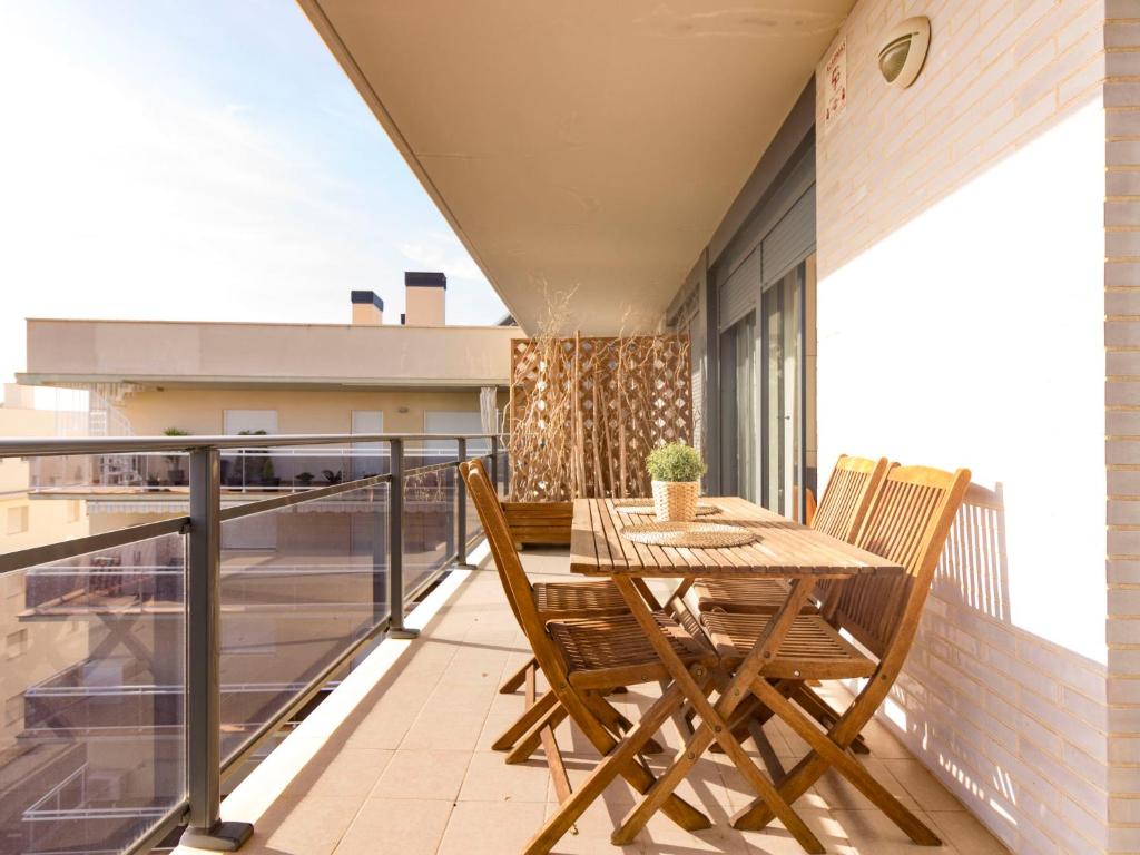 a balcony with a wooden table and chairs at Apartment Goleta-1 by Interhome in Cambrils