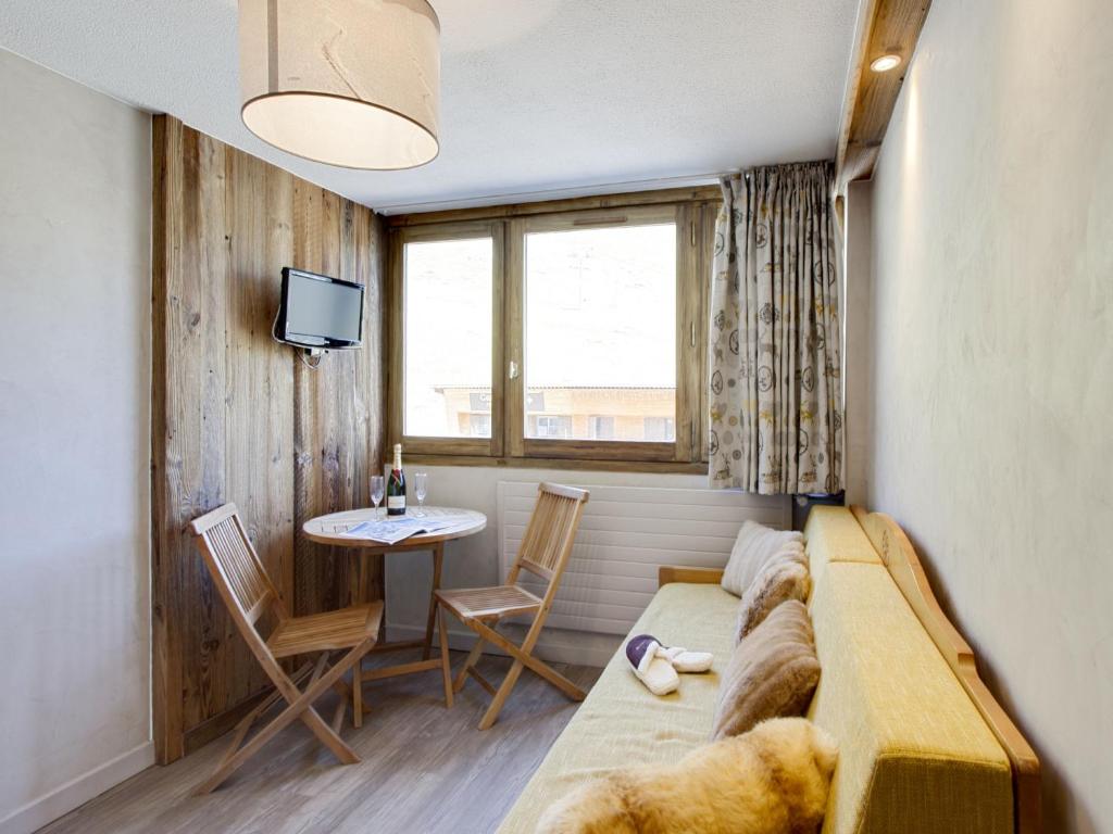 a room with a couch and a table and a television at Studio Palafour - Le Lac-3 by Interhome in Tignes