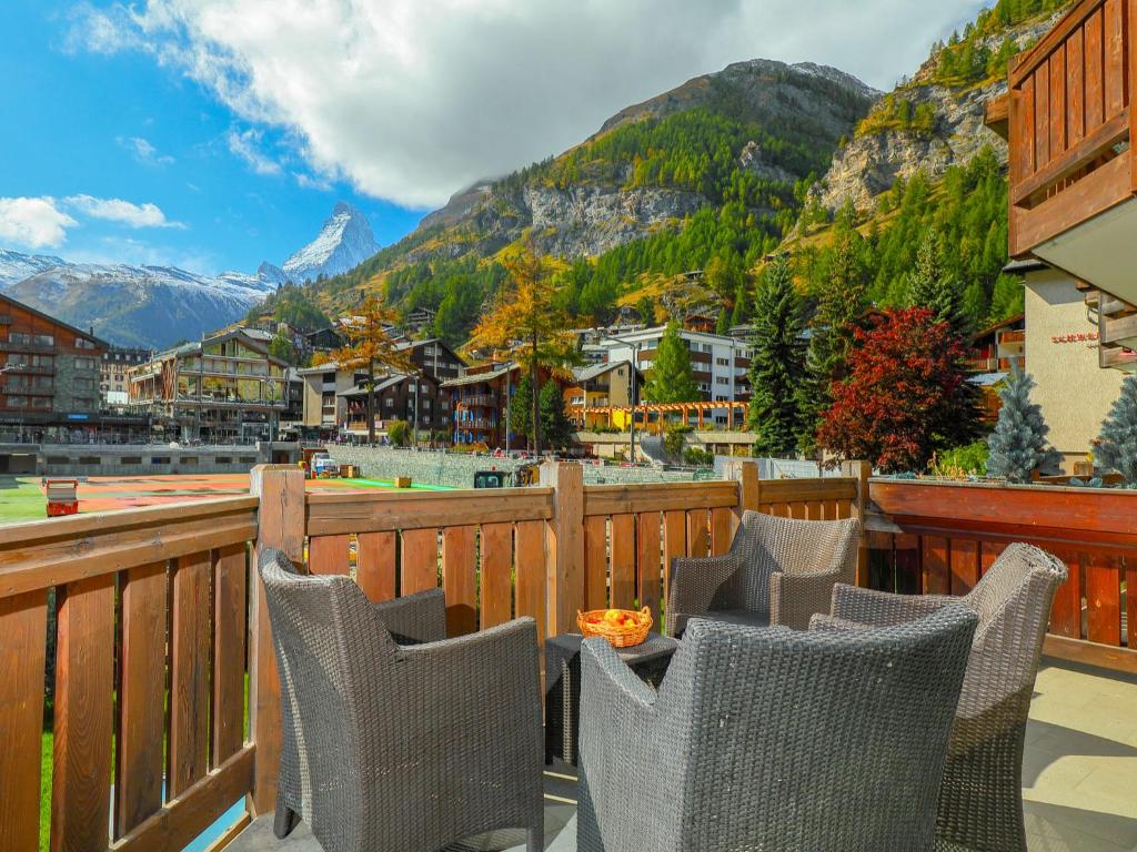 a balcony with chairs and a view of a mountain at Apartment Whymper by Interhome in Zermatt