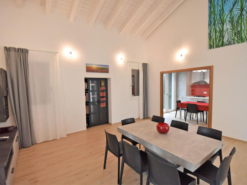 a dining room with a table and chairs in a room at Villa Cà Riviera Bosco Piccolo by Interhome in Malcontento