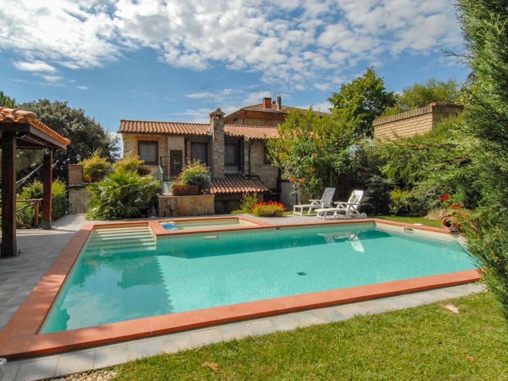 a swimming pool in the yard of a house at Villa Messi by Interhome in Castello di Montalera