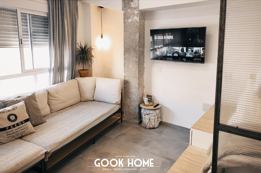 a living room with a couch and a tv at Gook Home BEACH in Málaga
