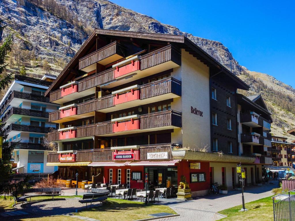 a large building with a mountain in the background at Apartment Haus Bellevue-7 by Interhome in Zermatt