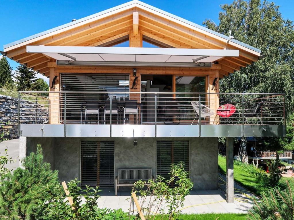 a house with a deck with a balcony at Chalet Les Penguins by Interhome in Nendaz