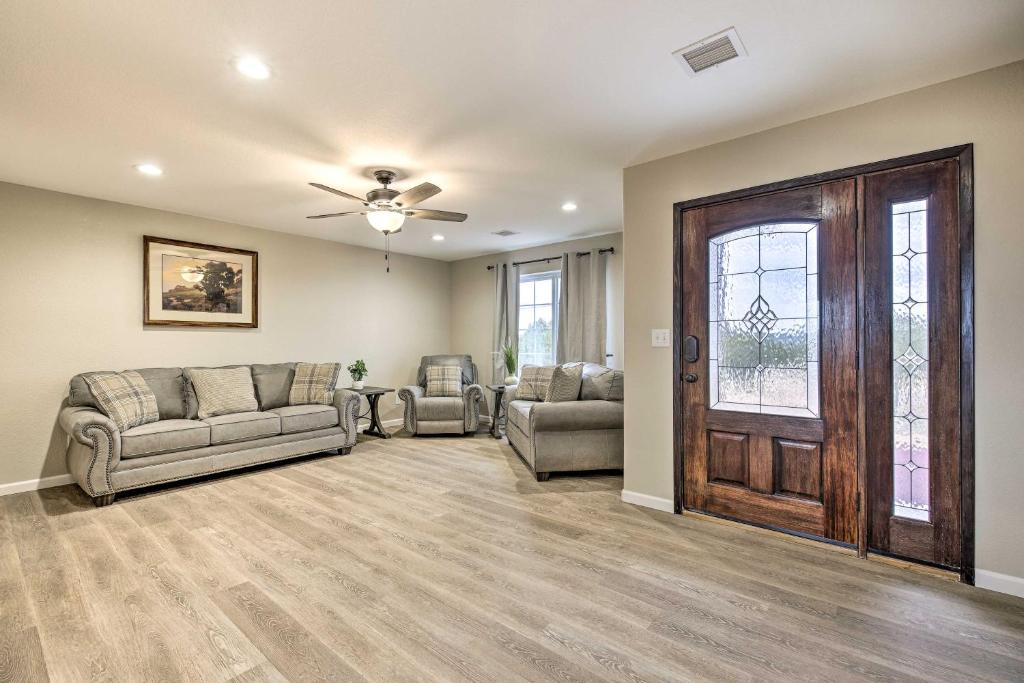 a living room with two couches and a door at Show Low Home with White Mountain Lake Access! in White Mountain Lakes Estates