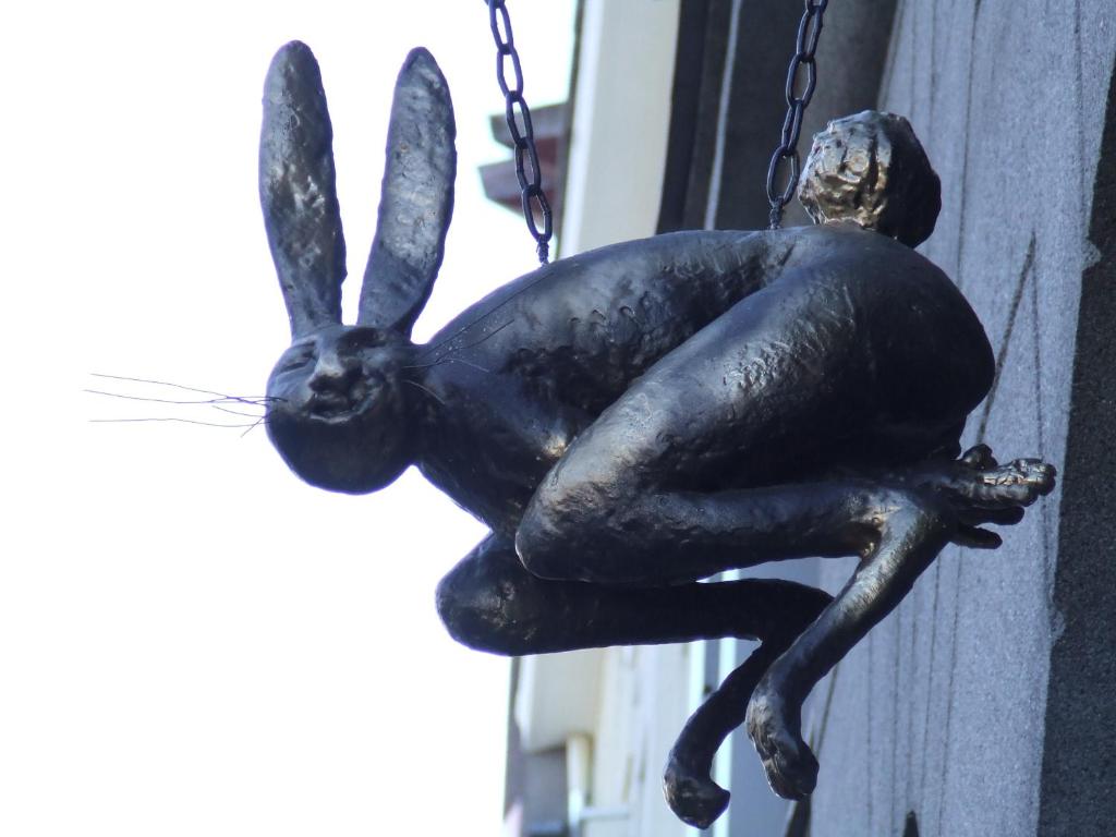 a statue of a rabbit hanging from a building at Karja Accommodation in Haapsalu