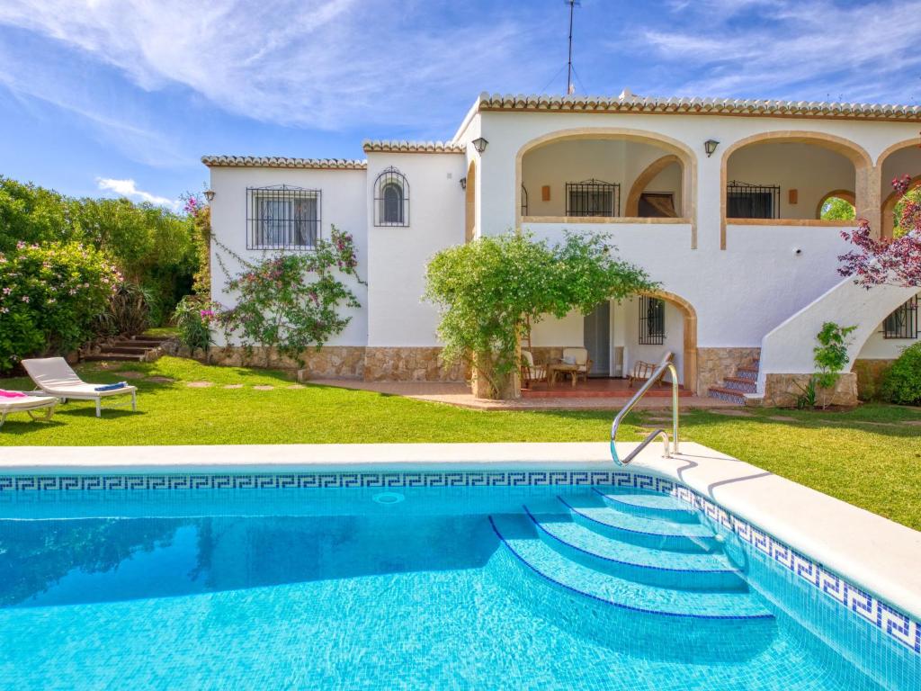 a villa with a swimming pool and a house at Villa Villa Louise by Interhome in Jávea