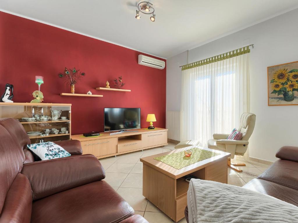 a living room with a couch and a tv at Apartment Laura by Interhome in Galižana