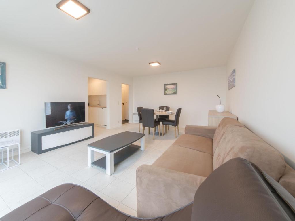 a living room with a couch and a table at Apartment Seaview 4 by Interhome in Bredene