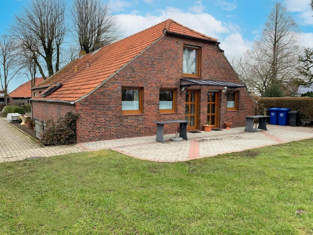 a brick house with a picnic table in front of it at Apartment Peters-2 by Interhome in Barkholt