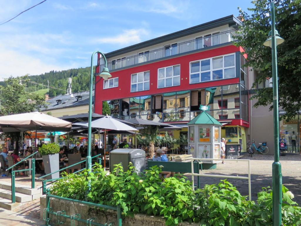 a large red building with a market in front of it at Apartment Papa Joe's Kuschelappartements-1 by Interhome in Schladming